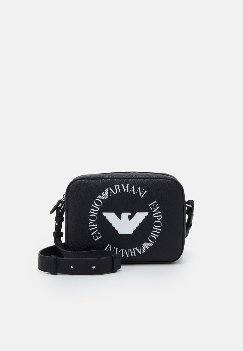 Black leather crossbody bag with a textured finish. Features a prominent white Emporio Armani logo and adjustable strap. Rectangular shape.