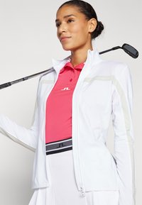 J.LINDEBERG Sports SEASONAL JANICE MID LAYER - Sportinė striukė - white