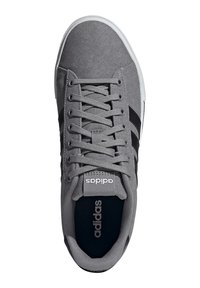 Gray canvas sneakers with black stripes, round toe, flat white rubber sole, and round laces; features an "adidas" logo on the tongue.