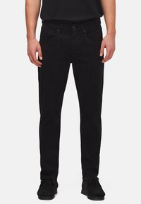 Sorte denim jeans med en slim-fit design, med knappelukning, fem-lomme stil og en glat tekstur. Båret med sorte sko.