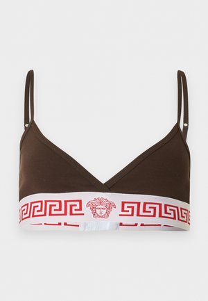 Καφέ bralette με λεπτές ρυθμιζόμενες τιράντες και λευκή ελαστική ταινία με κόκκινο μοτίβο ελληνικού κλειδιού και λογότυπο με κεφαλή Μενδούσης στο κέντρο.
