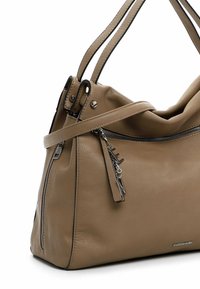 Beige leather handbag with a slouchy design, featuring a zippered pocket and a detachable strap. Metal accents add detail on the zipper.