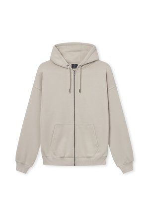 Hoodie zapinany na zamek w jasnym beżu, z kapturem na sznurki, przednimi kieszeniami oraz ściągaczami przy mankietach. Wykonany z miękkiego, gładkiego materiału o luźnym kroju.