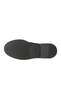 Suola di scarpa in gomma nera con un motivo di grip testurizzato, forma sagomata e un piccolo logo del marchio sul lato vicino al tallone.