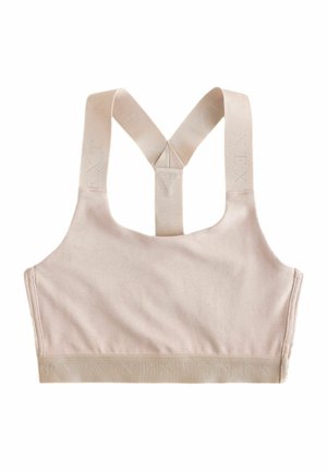 Reggiseno sportivo color beige chiaro con tessuto morbido, spalline incrociate larghe e una fascia elastica ampia con logo del marchio in rilievo lungo il fondo.