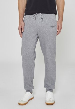 Pantaloni della tuta grigi realizzati in morbida miscela di cotone, con vita elasticizzata e coulisse, orli con polsini e logo stampato sul lato.