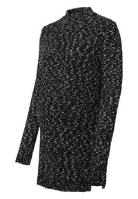 Haut en tricot noir et blanc à motifs mouchetés avec un col haut et des manches longues. Texture douce, coupe légèrement large, et fentes sur les côtés à l'ourlet.