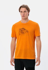 Korte mouwen oranje T-shirt van zachte stof, met een zwart grafisch ontwerp op de voorkant. Ronde hals en een relaxed fit.
