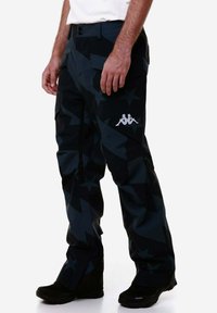 Pantaloni neri con motivo a stelle, dotati di tasca con zip e logo bianco sulla gamba sinistra. Realizzati in materiale resistente, progettati per l'abbigliamento sportivo.