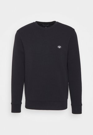 Sweatshirt bleu marine en tissu doux en mélange de coton, avec un col rond, des manches longues et un petit logo sur la poitrine.