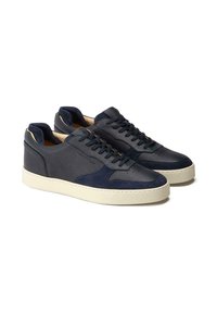 Navy leather sneakers with suede accents, featuring a low-top design, rounded toe, and white rubber sole; five pairs of eyelets for laces.