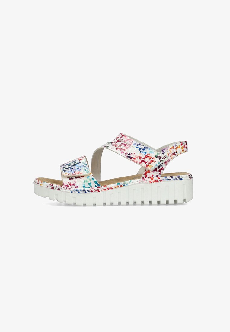 Sandales colorées avec une semelle plate-forme blanche, présentant un motif floral texturé dans des tons de rouge, bleu et orange sur les brides supérieures.
