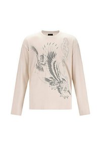 Helles beige Langarm-T-Shirt aus Baumwolle, mit einem grauen Adler-Grafikdesign und stilisiertem Text auf der Vorderseite.