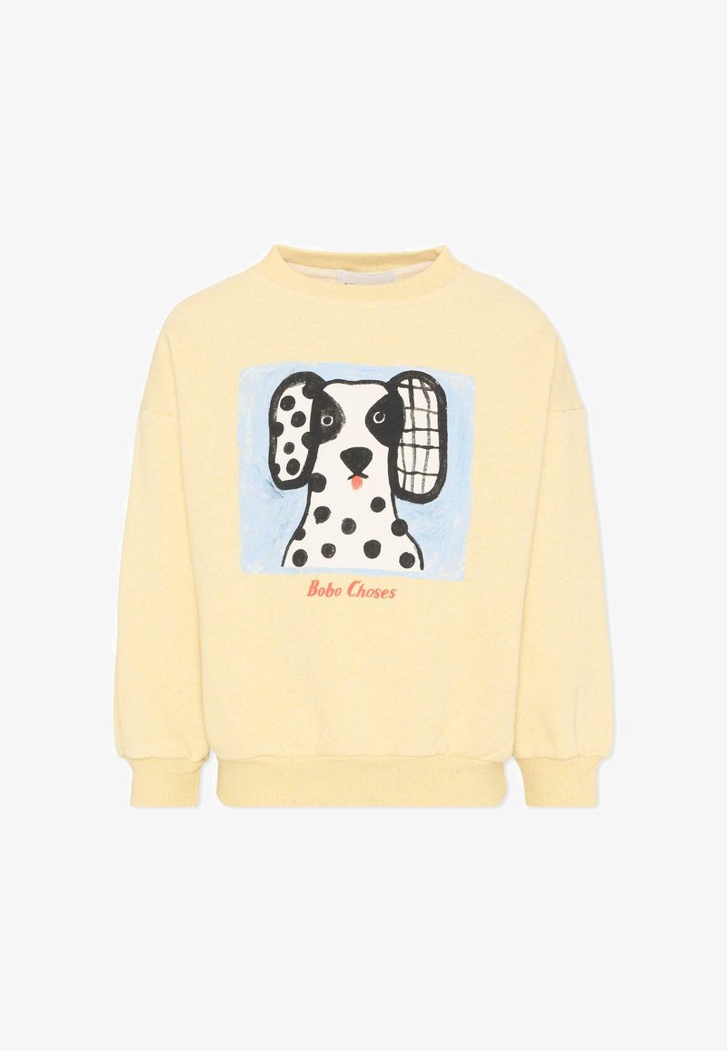 Sweatshirt jaune pâle avec un chien Dalmatien en dessin animé, aux oreilles de motifs différents, avec le texte "Bobo Choses" sous l'image.