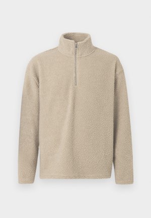 Pulover bej din fleece cu guler înalt și fermoar pe jumătate, având o suprafață texturată și mâneci lungi.