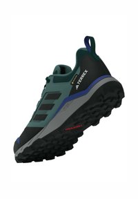 Herren Wanderschuhe mit einem dunkelgrünen synthetischen Obermaterial, schwarzen Akzenten, strukturierter Oberfläche und einer strapazierfähigen Gummisohle mit aggressivem Profil.