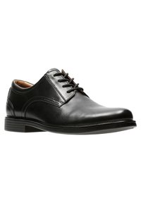 Schwarze Leder-Dressschuhe mit glatter Oberfläche, runder Zehenform, sechs Ösen und niedrigem, gestapeltem Absatz; mit dezentem Seitenstichdetail.