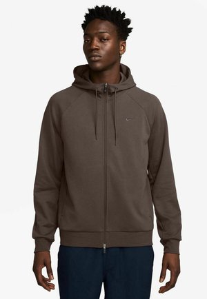 Brown zip-up hoodie with a drawstring hood, raglan sleeves, and embroidered logo on the chest. Smooth texture and fitted cuffs.