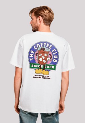White cotton t-shirt featuring a colorful graphic design on the back, depicting a cartoon coffee drink with ice cubes and playful text.