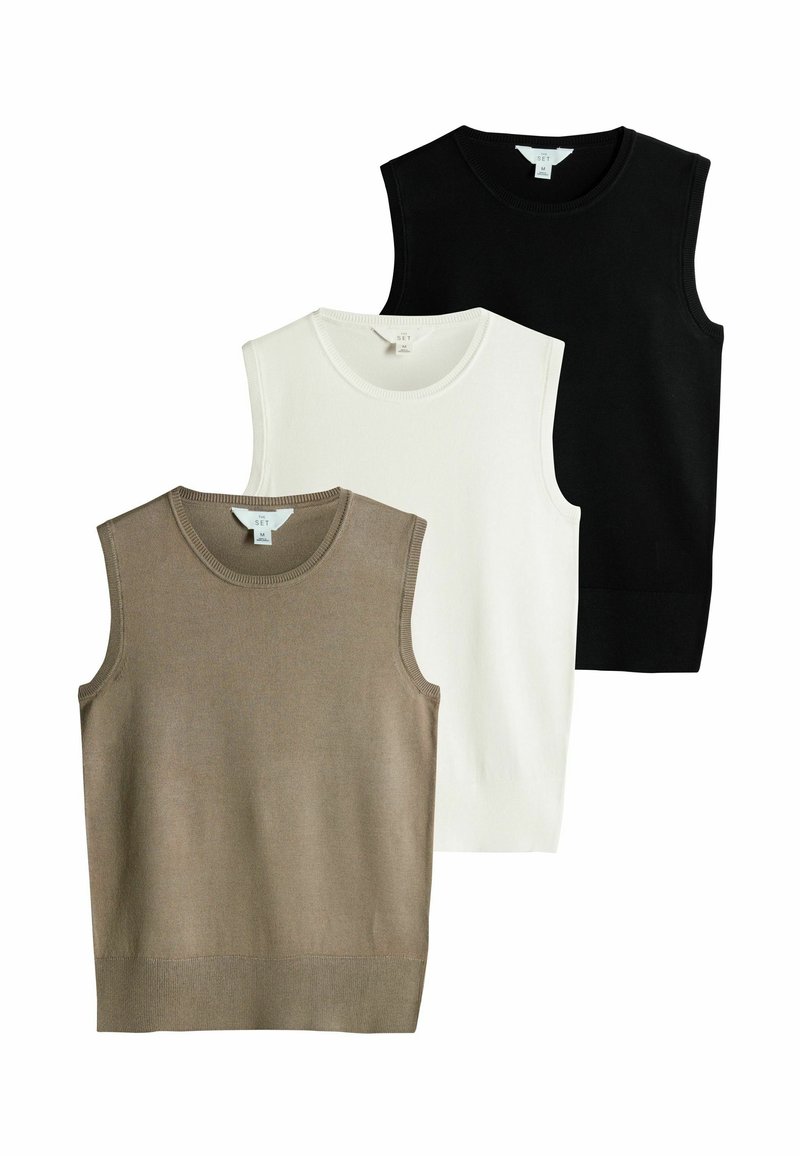 Tres jerséis sin mangas en beige, blanco y negro. Cada uno tiene un cuello acanalado y un tejido de punto suave, con un diseño ajustado.