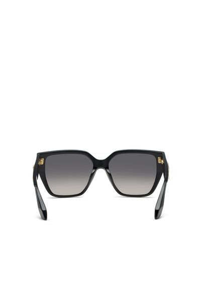 Lunettes de soleil carrées noires oversize avec verres foncés dégradés et accents décoratifs dorés sur les branches.