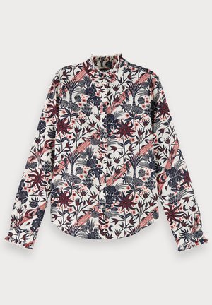 Langærmet skjorte i cremefarve med blomsterprint i marineblå og rød. Har en flæset krave og knaplukning foran med rynkede manchetter.