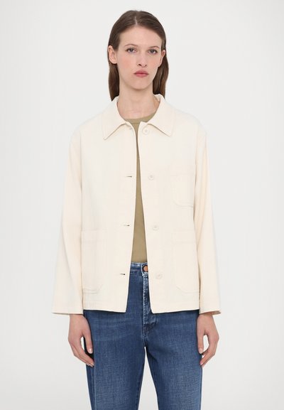 Light beige jacket with a collared neckline, front button closure, and two front pockets. Features long sleeves and a relaxed fit.