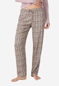 Pantalons de pyjama floraux en rose clair avec un fond noir. Dotés d'une taille élastique et d'un cordon de serrage. Coupez ample et tissu léger.