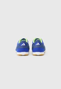 Blue athletic shoes made of mesh and synthetic material. Features green accents, white branding, and a rubber sole with a textured finish.