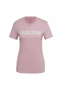 Růžové bavlněné tričko s kulatým výstřihem, krátkými rukávy a výrazným bílým logem "adidas" na přední straně. Klasický střih.