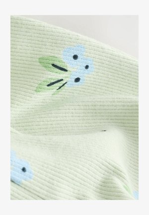 Heled rohelise tekstuuriga kangas, millel on helesinised lillemustrid ja rohelised lehed. Omab soonikujundust ja kontrastset musta aktsentidega.