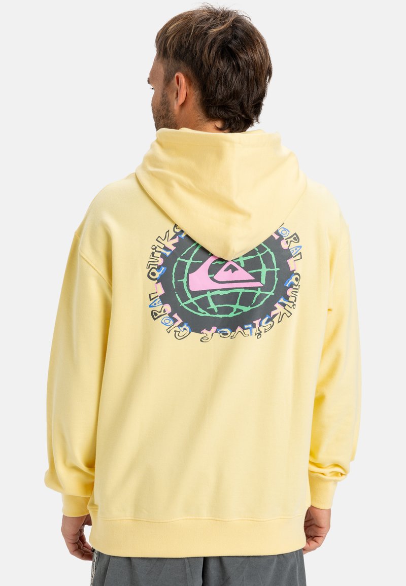 Yellow hooded sweatshirt featuring a large graphic on the back, with a globe design, Quiksilver logo, and text in various colors.