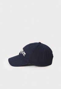 Navy blue cotton baseball cap with a curved brim, featuring white text on the front. It has stitched detailing and a button on top.
