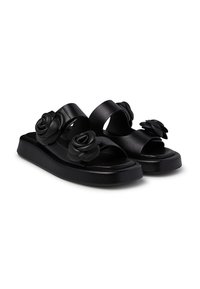 Black sandals with two wide straps and textured rose appliqués, featuring a flat platform sole and open toe design.