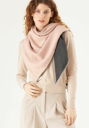 Light pink and dark gray triangular scarf made of soft fabric, featuring a stitched edge and draped styling, worn over a beige top.