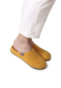 Yellow felt slippers with a slip-on design, round toe, and a grey rubber sole. Accented with a small label on the side.