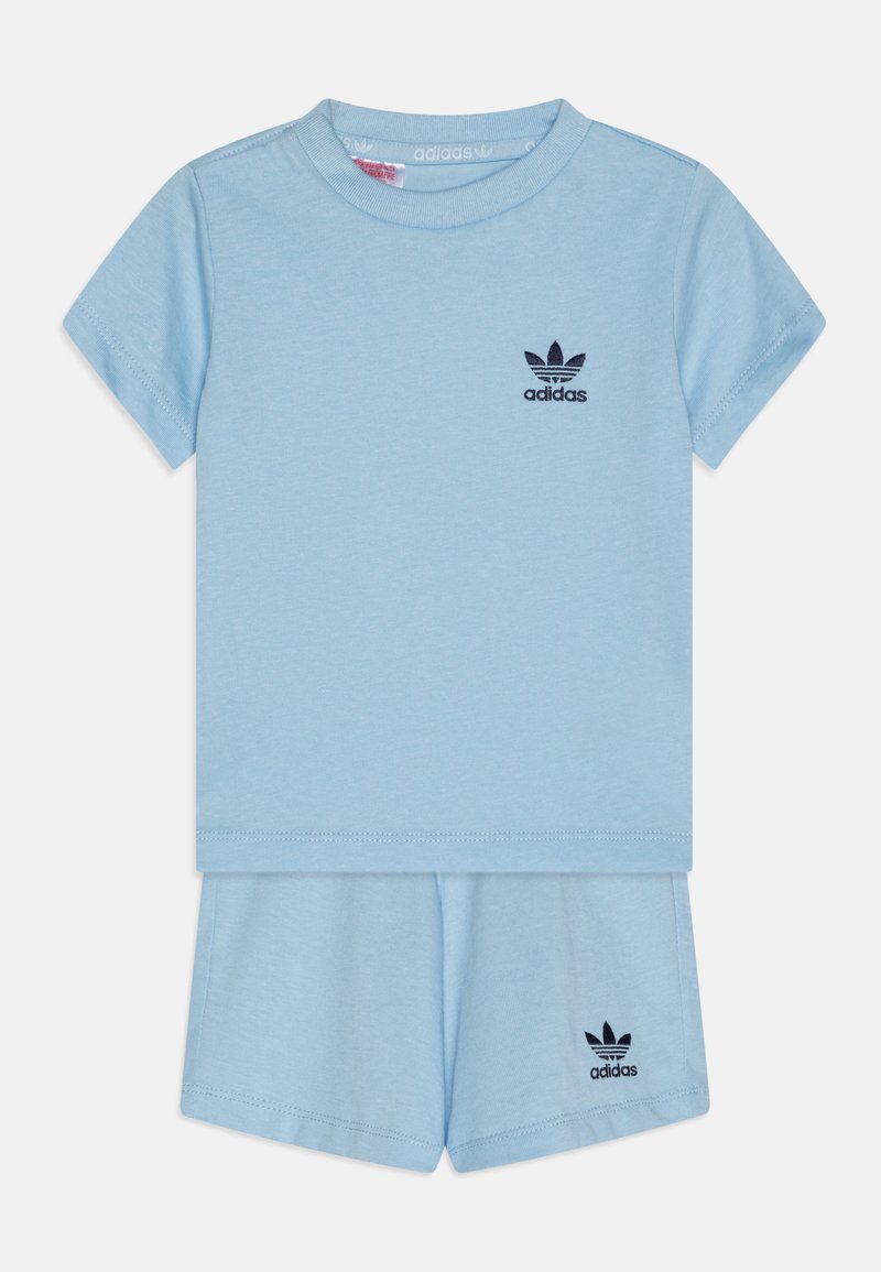 Light blue cotton two-piece set featuring a short-sleeve top and matching shorts, accented with a black Adidas logo on both items.