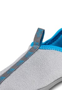 Gray slip-on shoe with a textured surface, blue accents, and gray stitching. Features a looped heel tab for easy wear.
