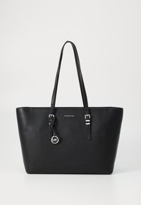 Black leather tote bag with textured surface, dual top handles, silver hardware, and an attached round MK logo charm.