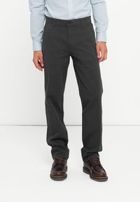 Gray, straight-leg trousers made of cotton blend, featuring a button closure and side pockets, paired with dark brown lace-up shoes.