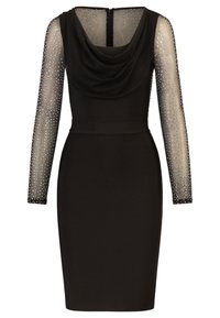 Schwarzes Kleid mit einem Cowl-Ausschnitt, langen durchsichtigen Ärmeln, die mit silbernen Nieten verziert sind, und einer figurbetonten Form, die einen Reißverschluss auf der Rückseite hat.
