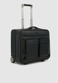 Valigia nera con superficie texturizzata, due tasche frontali, manico retrattile e due ruote per una facile mobilità.