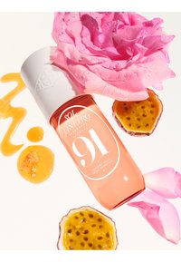 Roze geurmistfles met witte dop, gelabeld "91." Omringd door roze rozenblaadjes, passievruchtschil en honingdruppels.