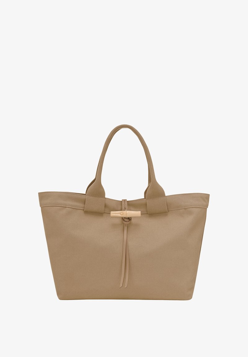 Tan canvas tote bag with dual handles, a wooden toggle closure, and textured surface, featuring minimalistic design and no additional accents.