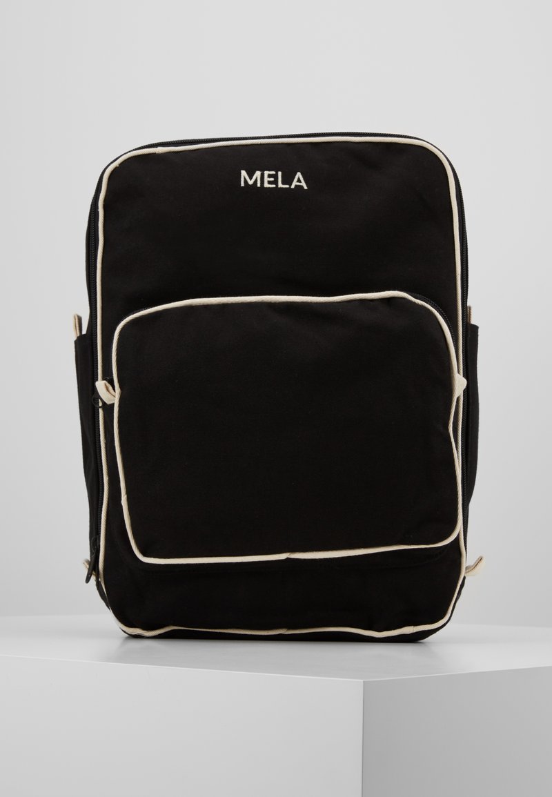 Black backpack made of fabric, featuring a front pocket with cream trim, dual side pockets, and the brand name "MELA" in white.