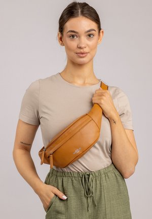 Brown leather crossbody bag with textured finish, featuring two zippered compartments and a wide adjustable strap. Please refer to the brand logo.