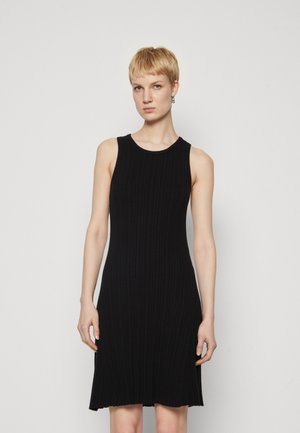 Black ribbed dress with a sleeveless design, round neckline, and flared hem. Made of stretchy fabric, featuring vertical pattern details.