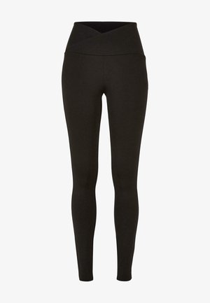 Leggings noirs avec une taille haute et croisée. Fabriqués dans un tissu extensible et lisse, ils présentent un design ajusté sans coutures visibles.