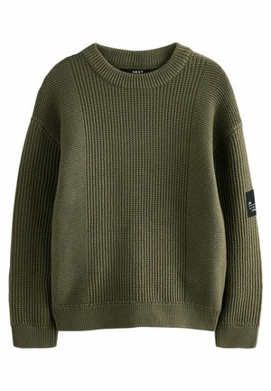 Groene geribde gebreide trui met een ronde hals, textuurpatronen en aansluitende manchetten. Heeft een zijlabel met de merknaam op de mouw.