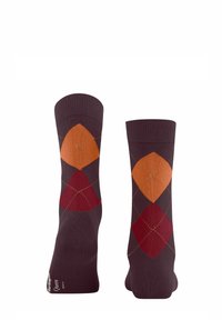 Chaussettes violettes foncées avec un motif en losange orange, rouge et rouille, avec des coutures contrastées. Poignets côtelés en haut.
